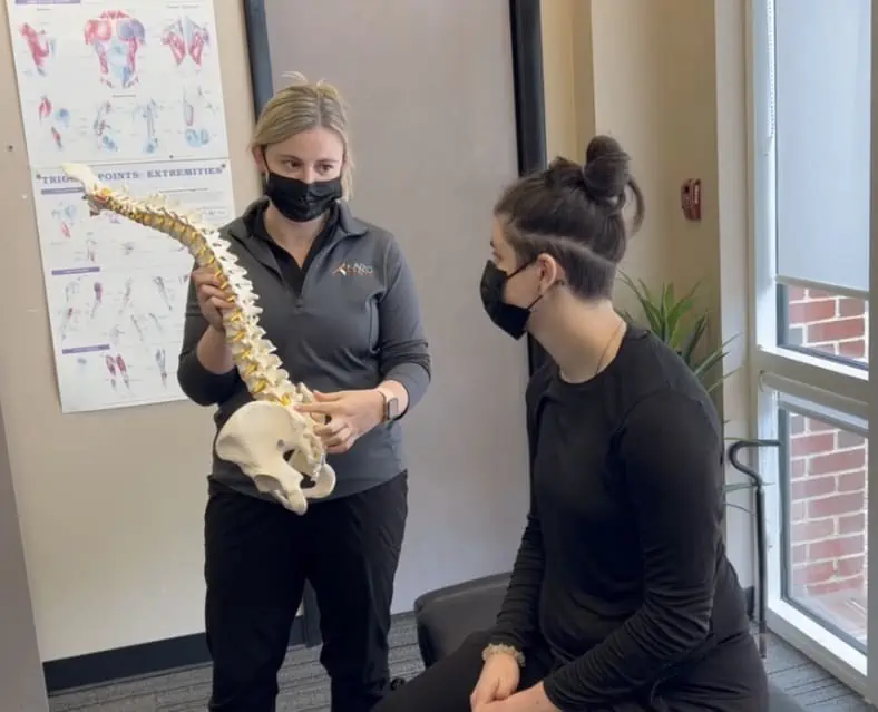 Chiropractor teaching patient about the spine